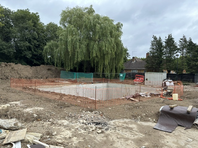 Completed basement excavation fenced off ahead of construction